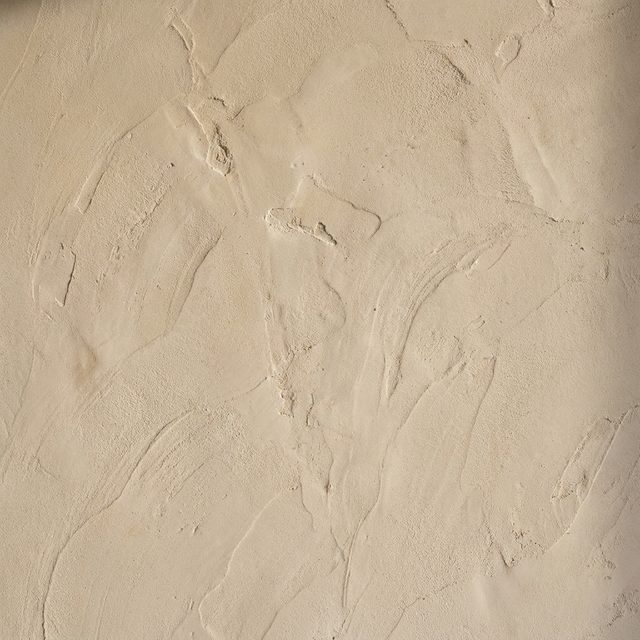 Hand troweled lime plaster surface in warm bone